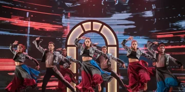 Bailarines de danza española en una actuación innovadora que fusiona elementos tradicionales y contemporáneos en un escenario moderno.