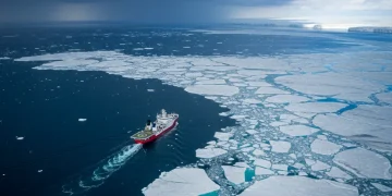 Vast Arctic landscape with melting ice, open water, and a research vessel, symbolizing strategic importance.