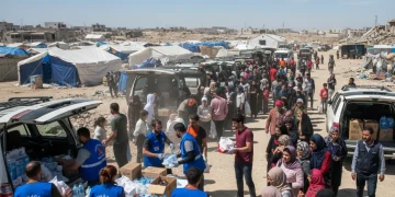 Humanitarian aid workers distributing supplies in a global crisis zone, embodying international relief efforts.