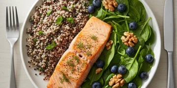 Colorful anti-inflammatory meal with salmon, quinoa, and berries.